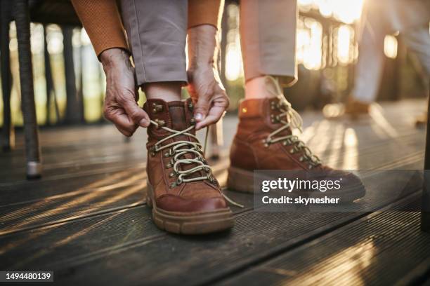 tying shoelace on boots! - lace stockfoto's en -beelden