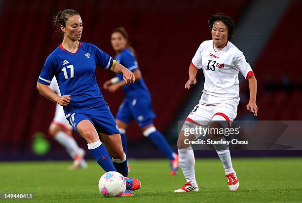 Gaetane Thiney of France controls the ball against O Hui Sun of DPR Korea during the Women's Football first round Group G match between France and...