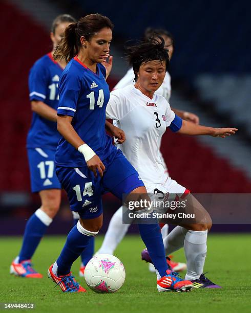 Louisa Necib of France holds off Kim Myong Gum of DPR Korea during the Women's Football first round Group G match between France and DPR Korea on Day...