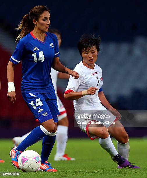 Louisa Necib of France holds off Kim Myong Gum of DPR Korea during the Women's Football first round Group G match between France and DPR Korea on Day...