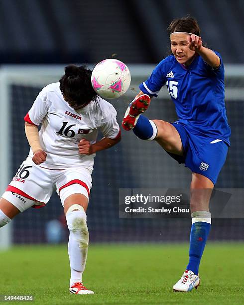 Elise Bussaglia of France battles with Kim Song Hui of DPR Korea during the Women's Football first round Group G match between France and DPR Korea...