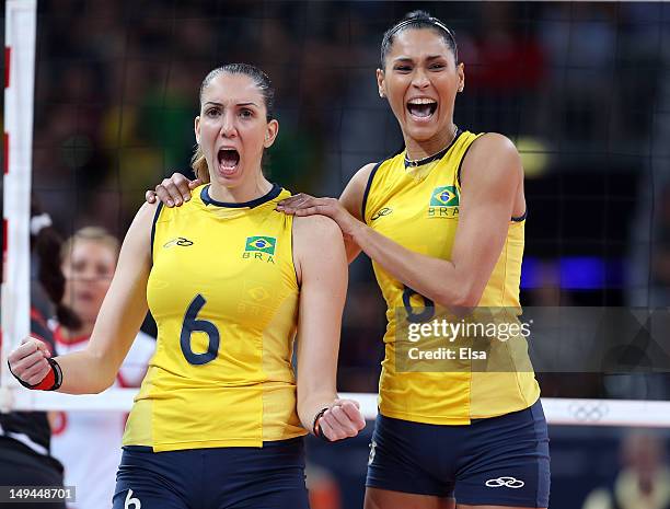 Thaisa Menezes celebrates her blocked shot with teamamate Jaqueline Carvalho of Brazil in the second set against Turkey during Women's Volleyball on...