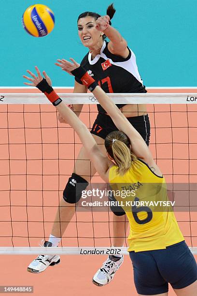 Turkey's Neslihan Darnel spikes as Brazil's Thaisa Menezes attempts to block during the women's volleyball match between Turkey and Brazil in the...