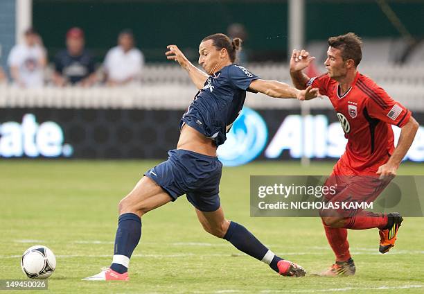 Paris Saint-Germain's new Swedish signing Zlatan Ibrahimovic vies with DC United's Emiliano Dudar durng a friendly match in Washington on July 28,...