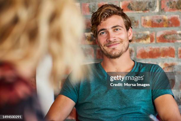 loving young man looking at woman in house - verlieben stock-fotos und bilder