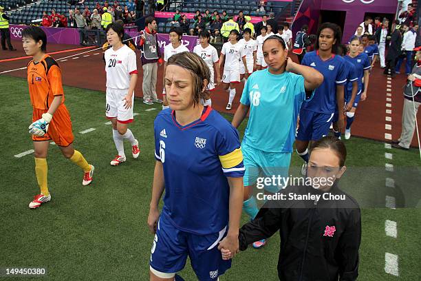 France and DPR Korea players enter the field during the Women's Football first round Group G match between France and DPR Korea on Day 1 of the...