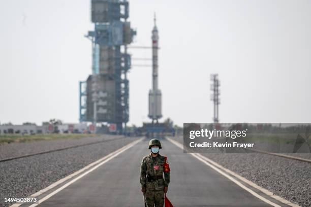 Soldier stands guard in front of the launch site of the Shenzhou-16 spacecraft onboard the Long March-2F rocket of the China Manned Space Agency...