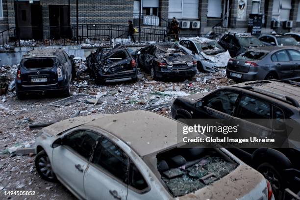 Damaged cars stand amid debris in a yard of a residential building hit by shelling on May 30, 2023 in Kyiv, Ukraine. That night, explosions rang out...