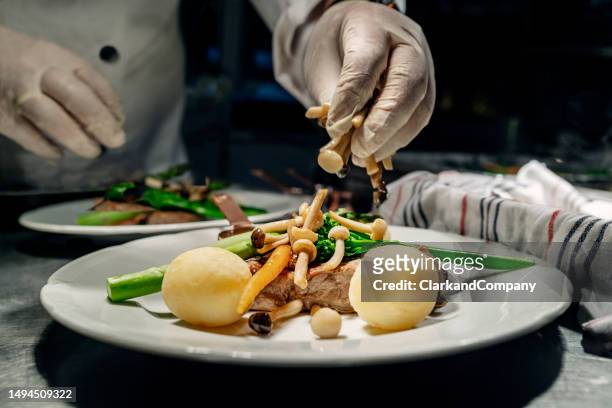 chef - enoki mushroom stock pictures, royalty-free photos & images