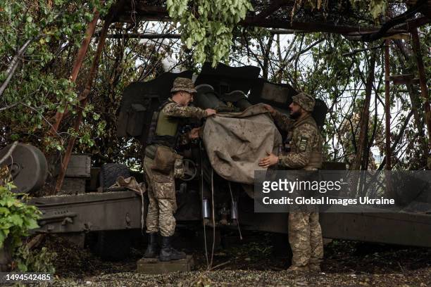 Ukrainian artillerymen stand near towed gun-howitzer D-20 on position on Bakhmut direction on May 28, 2023 in Donetsk Oblast, Ukraine. Bakhmut and...