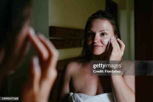 a beautiful woman in the bathroom near the mirror - negligée stock-fotos und bilder