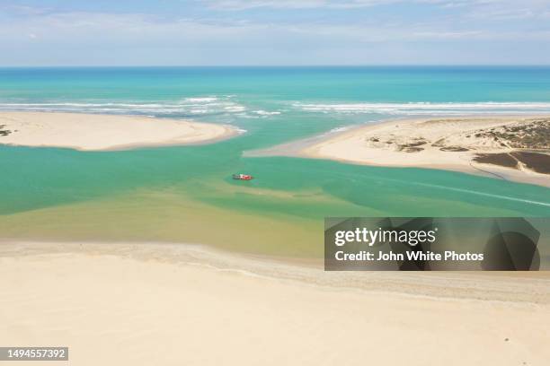 drenching sand from the entrance of the murray river mouth. sand building up where the murray river enters the sea. the coorong. south australia. - sandbar stock pictures, royalty-free photos & images