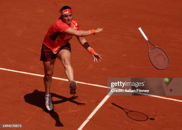 Ons Jabeur of Tunisia throws her racket in vain against Lucia Bronzetti of Italy during their Women's Singles First Round Match on Day Three of the...