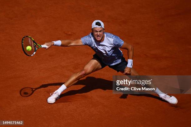 Holger Rune of Denmark plays a forehand against Christopher Eubanks of United States during their Men's Singles First Round Match on Day Three of the...