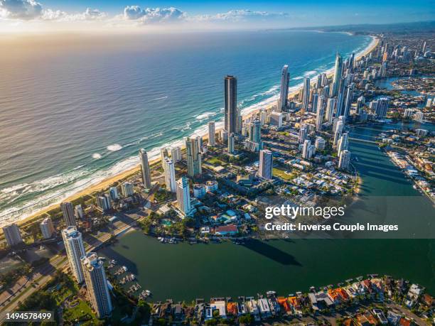 aerial view scene of gold coast beach behind around surfers paradise skyline, broadbeach and main beach with luxury hotel and apartment when sunrise time at gold coast - main beach gold coast stock pictures, royalty-free photos & images