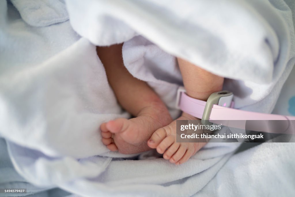 Baby - Human Age,Foot of newborn baby on warm blanket.