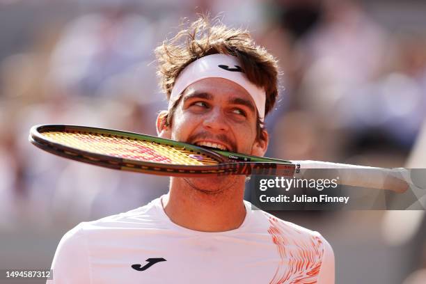 Thiago Seyboth Wild of Brazil reacts as they bite their racket against Daniil Medvedev during their Men's Singles First Round Match on Day Three of...