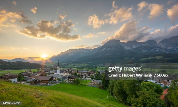 scenic view of townscape and mountains against sky,ellmau,austria - ellmau stock-fotos und bilder