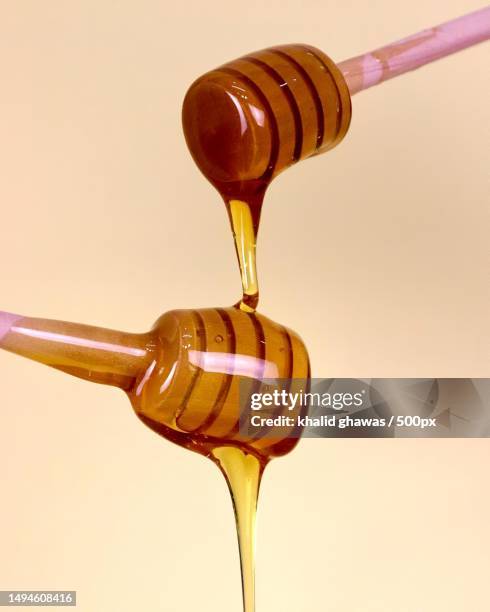 close-up of honey dipper on beige background,oman - honey dipper stock pictures, royalty-free photos & images