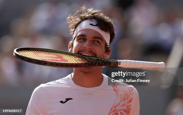 Thiago Seyboth Wild of Brazil bites the racket as he reacts against Daniil Medvedev during their Men's Singles First Round Match on Day Three of the...