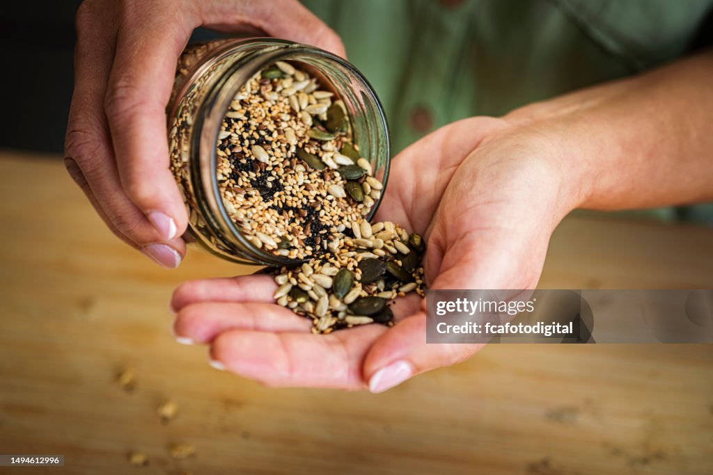 Healthy seeds and nuts on the palm of hand