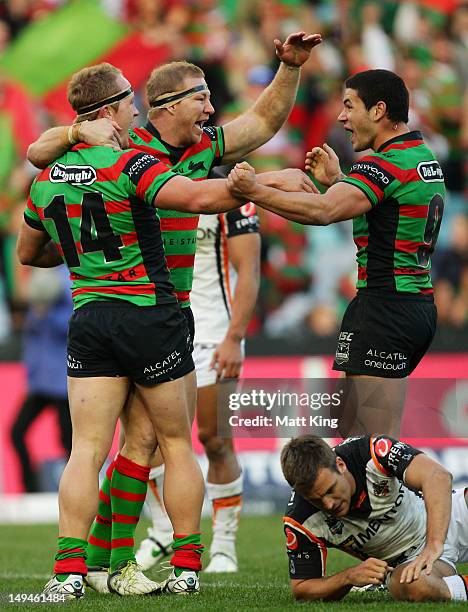 Jason Clark of the Rabbitohs celebrates with Michael Crocker and Nathan Peats after scoring a try during the round 21 NRL match between the South...