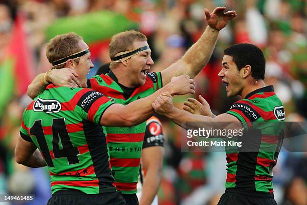 Jason Clark of the Rabbitohs celebrates with Michael Crocker and Nathan Peats after scoring a try during the round 21 NRL match between the South...