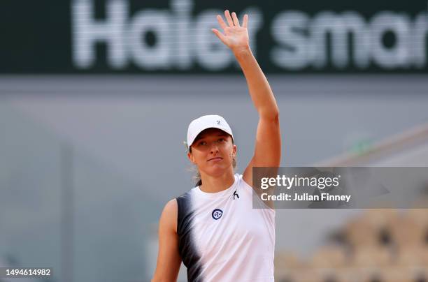 Iga Swiatek of Poland celebrates winning match point against Cristina Bucsa of Spain during their Women's Singles First Round Match on Day Three of...