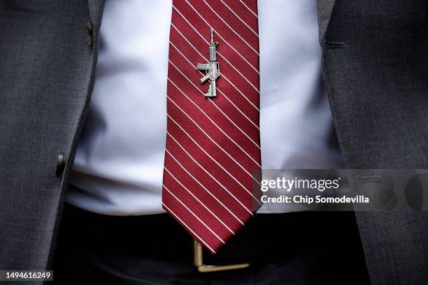 House Freedom Caucus memeber Rep. Andrew Clyde sports an assault rifle tie pin during a news conference where he announced that he and many of his...