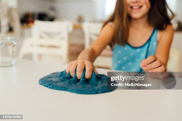 girl playing with sticky slime - goop stockfoto's en -beelden