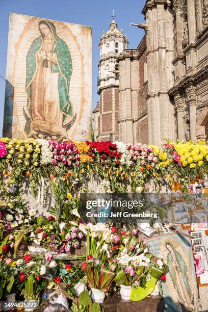 Mexico City, Mexico, Day of the Virgin of Guadalupe, Plaza Mariana Avenida Montevideo, religious offerings and flowers at memorial.