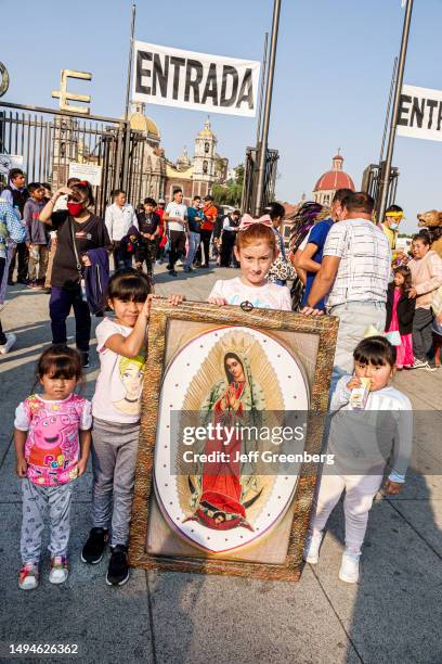 Mexico City, Mexico, Day of the Virgin of Guadalupe, Plaza Mariana Avenida Montevideo, crowds of pilgrims carrying religious icon portraits.