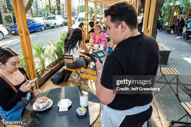 Mexico City, Mexico, Panaderia Rosetta bakery, waiter running credit card payment.