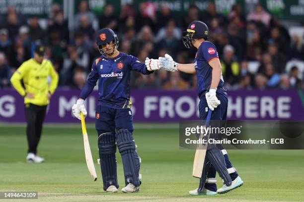 Robin Das of Essex is congratulated on his half century by team mate Matthew Critchley during the Vitality Blast T20 match between Essex and...