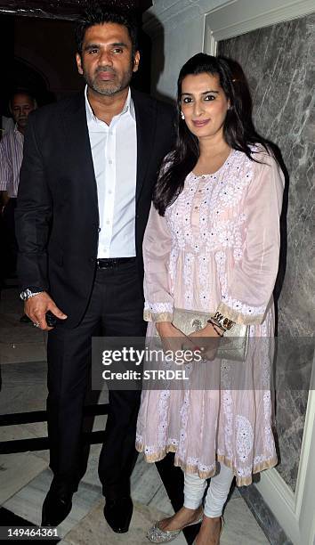 Indian Bollywood actor Sunil Shetty with wife Mana Shetty attend a press conference on Hepatitis B in Mumbai on July 28, 2012. AFP PHOTO/STR