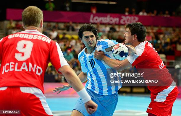 Argentina's Federico Matias Vieyra vies with Iceland's leftback Arnor Atlason during the men's preliminaries Group A handball match Iceland vs...