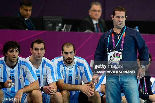 Argentina's coach Eduardo Emmanuel Migueles reacts next to Argentina's Gonzalo Matias Carou, Pablo Sebastian Portela and Leonardo Facundo Querin...