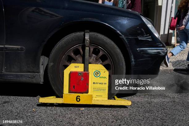 An illegally parked car is seen immobilized by the Traffic Authority in Rua Moeda, Cais do Sodre, on May 30, 2023 in Lisbon, Portugal. Influx of...
