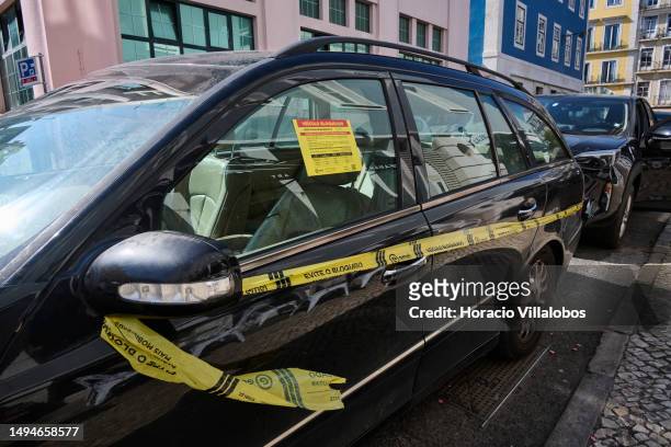 An illegally parked car is seen immobilized by the Traffic Authority in Rua Moeda, Cais do Sodre, on May 30, 2023 in Lisbon, Portugal. Influx of...
