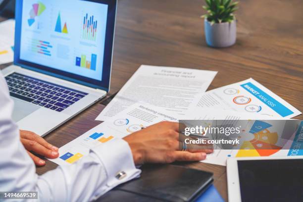 close up of business man working with documents with financial charts graphs and finance figures. - bookkeeping stock pictures, royalty-free photos & images
