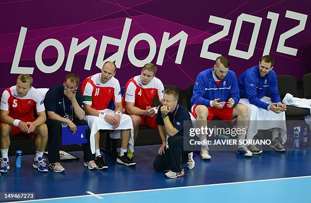 Iceland's leftback Ingimundur Ingimundarson , rightback Olafur Stefansson , centreback Aron Palmarsson and their coach Gudmundur Gudmundsson react...