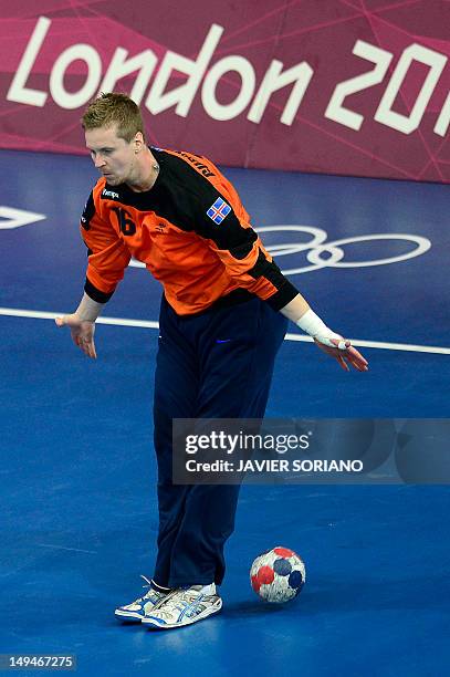 Iceland's goalkeeper Hreidar Levy Gudmundsson tries to make a save during the men's preliminaries Group A handball match Iceland vs Argentina for the...