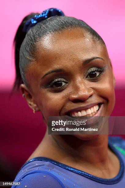 Daiane dos Santos of Brazil smiles after she competes in the uneven bars in the Artistic Gymnastics Women's Team qualification on Day 2 of the London...