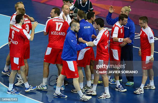 Icelandic players celebrate their victory over Argentina by 31-25 at the end of the men's preliminaries Group A handball match Iceland vs Argentina...