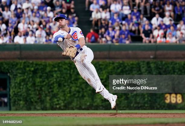 Nico Hoerner of the Chicago Cubs throws to first and gets Wander Franco of the Tampa Bay Rays out during the third inning of a game at Wrigley Field...