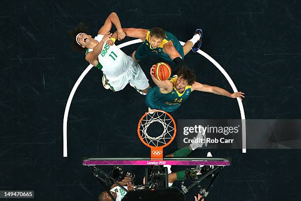 Anderson Varejao of Brazil gets fouled by David Andersen of Australia as Matt Nielsen goes for the rebound during their Men's Basketball Game on Day...