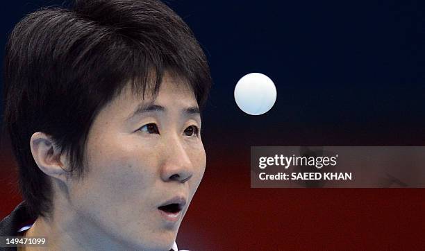 Tan Wenling of Italy serves to Anna Tikhomirova of Russia during a table tennis women's single preliminary round match of the London 2012 Olympic...