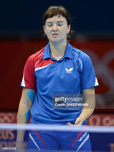 Anna Tikhomirova of Russia reacts after lsoing a point to Tan Wenling of Italy during their table tennis women's singles preliminary round match of...