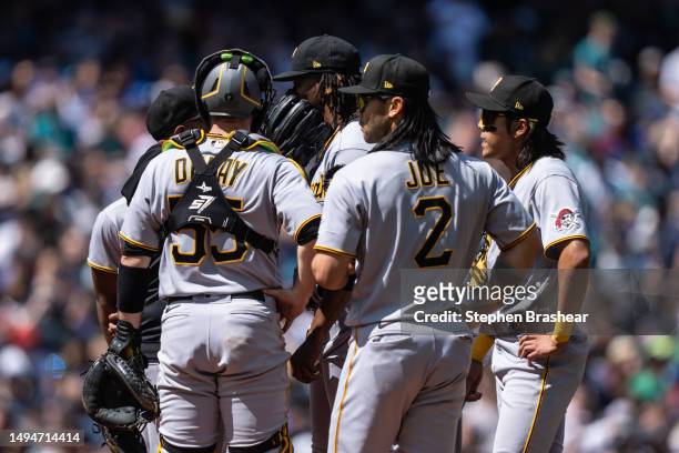 Relief pitcher Jose Hernandez of the Pittsburgh Pirates meets at the mound with catcher Jason Delay, first baseman Connor Joe and second baseman Ji...