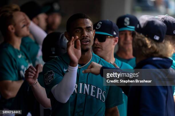 Julio Rodriguez of the Seattle Mariners is congrtulated in the dugout after scoring a run during a game against the Pittsburgh Pirates at T-Mobile...